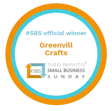 A circular emblem with two concentric rings, one orange and one blue, featuring text recognizing an ’official winner’ and a ’Small Business Sunday’ award.